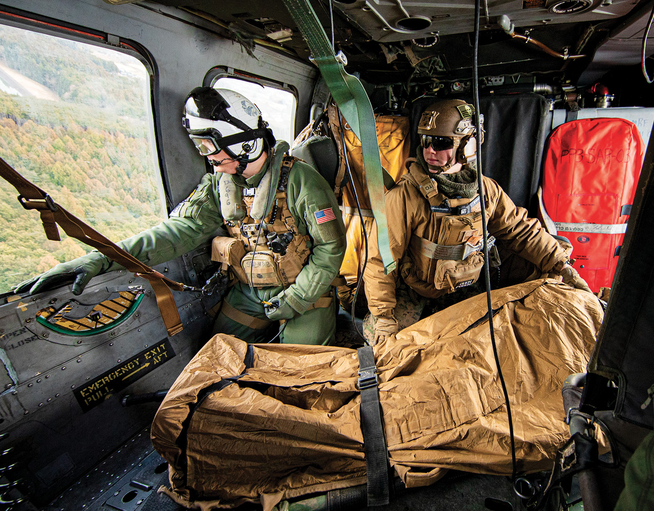 Naval Air Crewman (Helicopter) 1st Class Van Mansfield, assigned to Helicopter Sea Combat Squadron 12, and Marines assigned to 3rd LightArmored Reconnaissance Battalion, 31st Marine Expeditionary Unit, transport simulated patient in MH-60S Seahawk during medical evacuationtraining at Combined Arms Training Center Camp Fuji, Japan, February 4, 2025 (U.S. Navy/Geoffrey L. Ottinger)